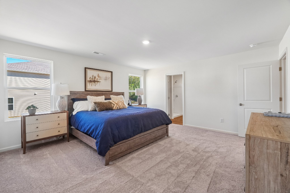 A bedroom with a bed and a dresser.