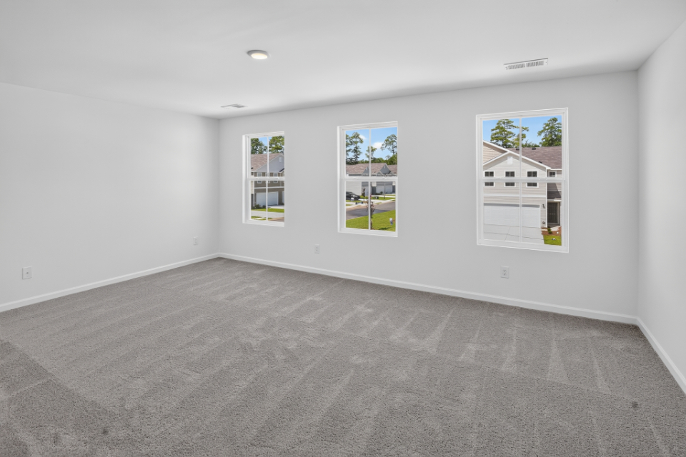 A white room with a few paintings on the wall.