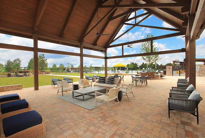 A patio with chairs and tables.