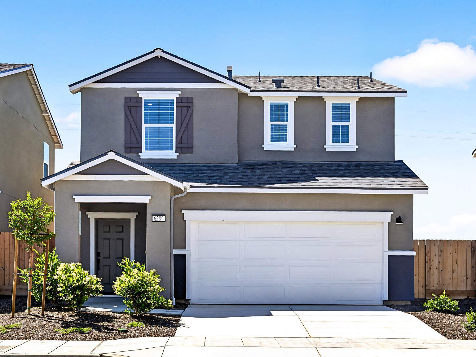 A house with garages and a fence.