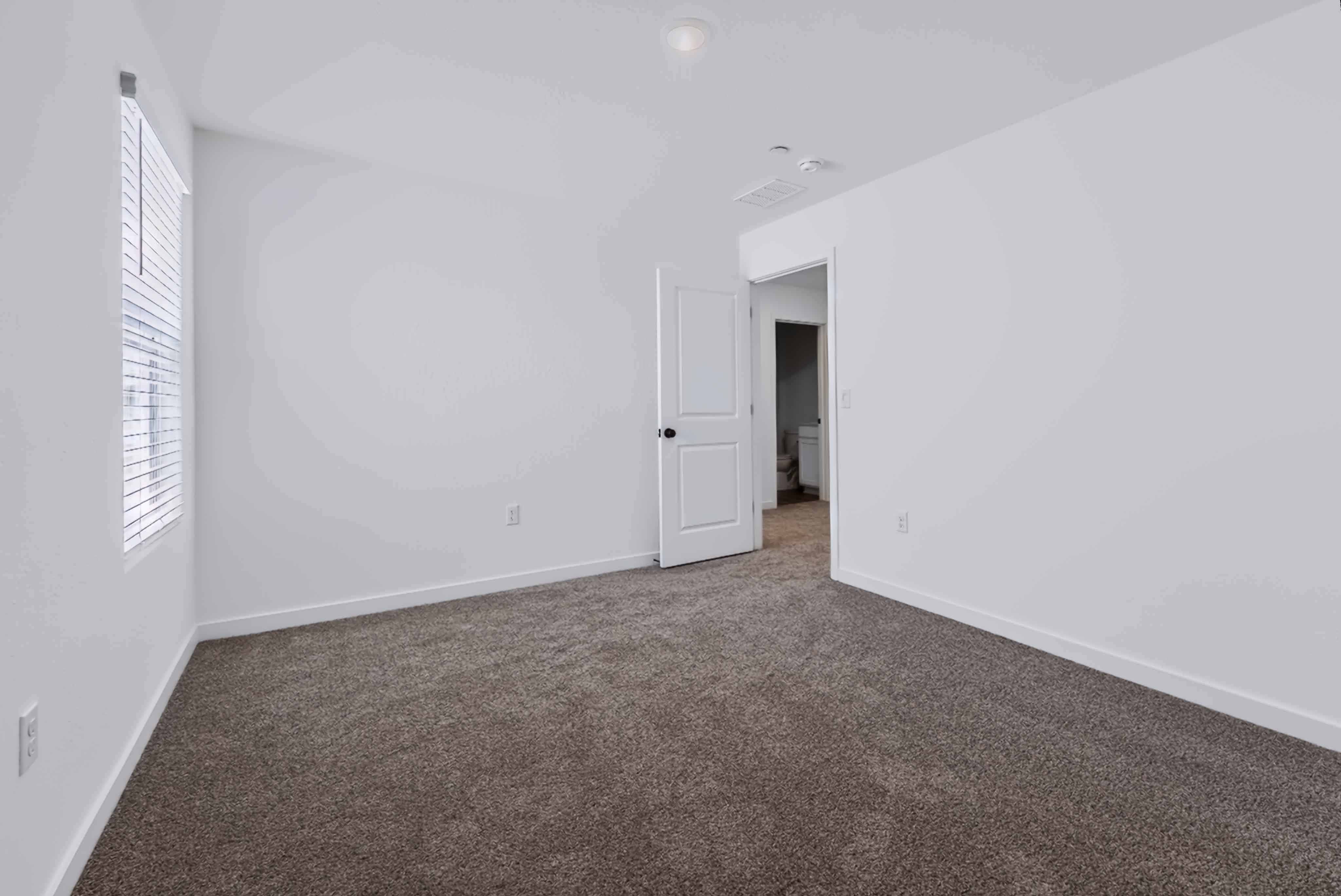 A hallway with white walls.