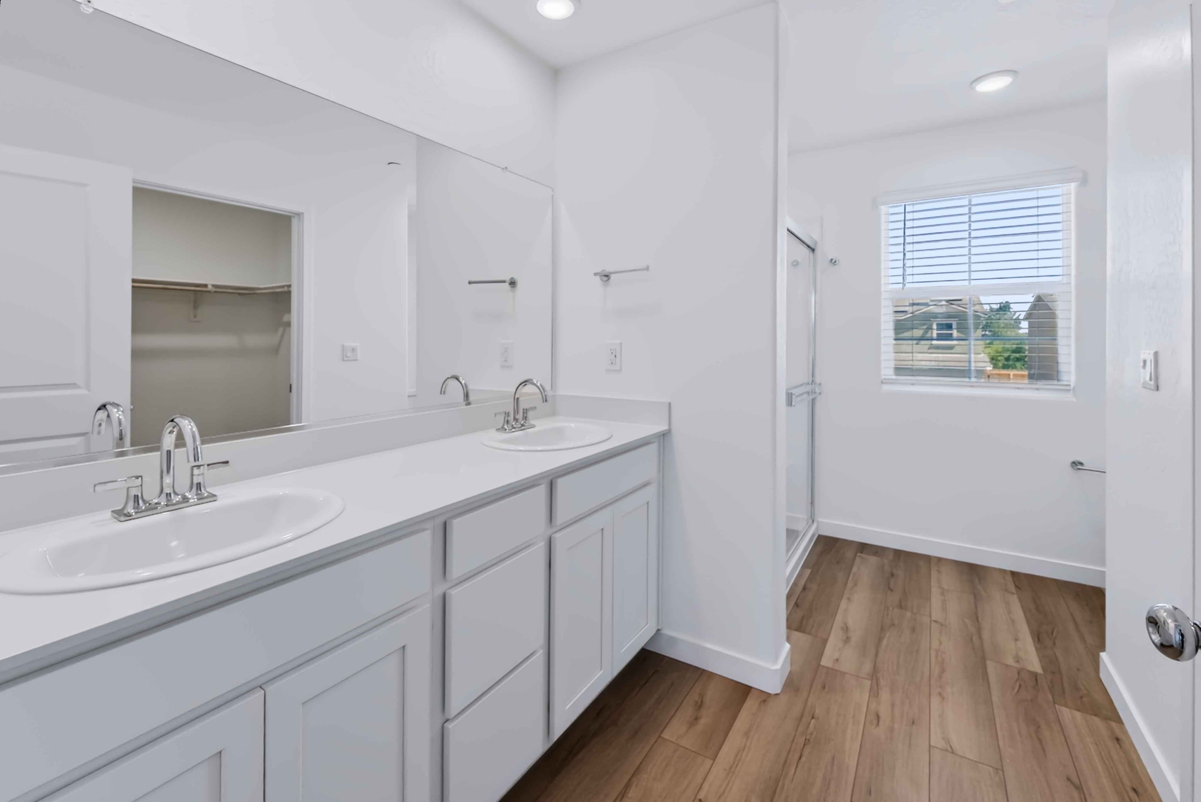 A bathroom with white cabinets.