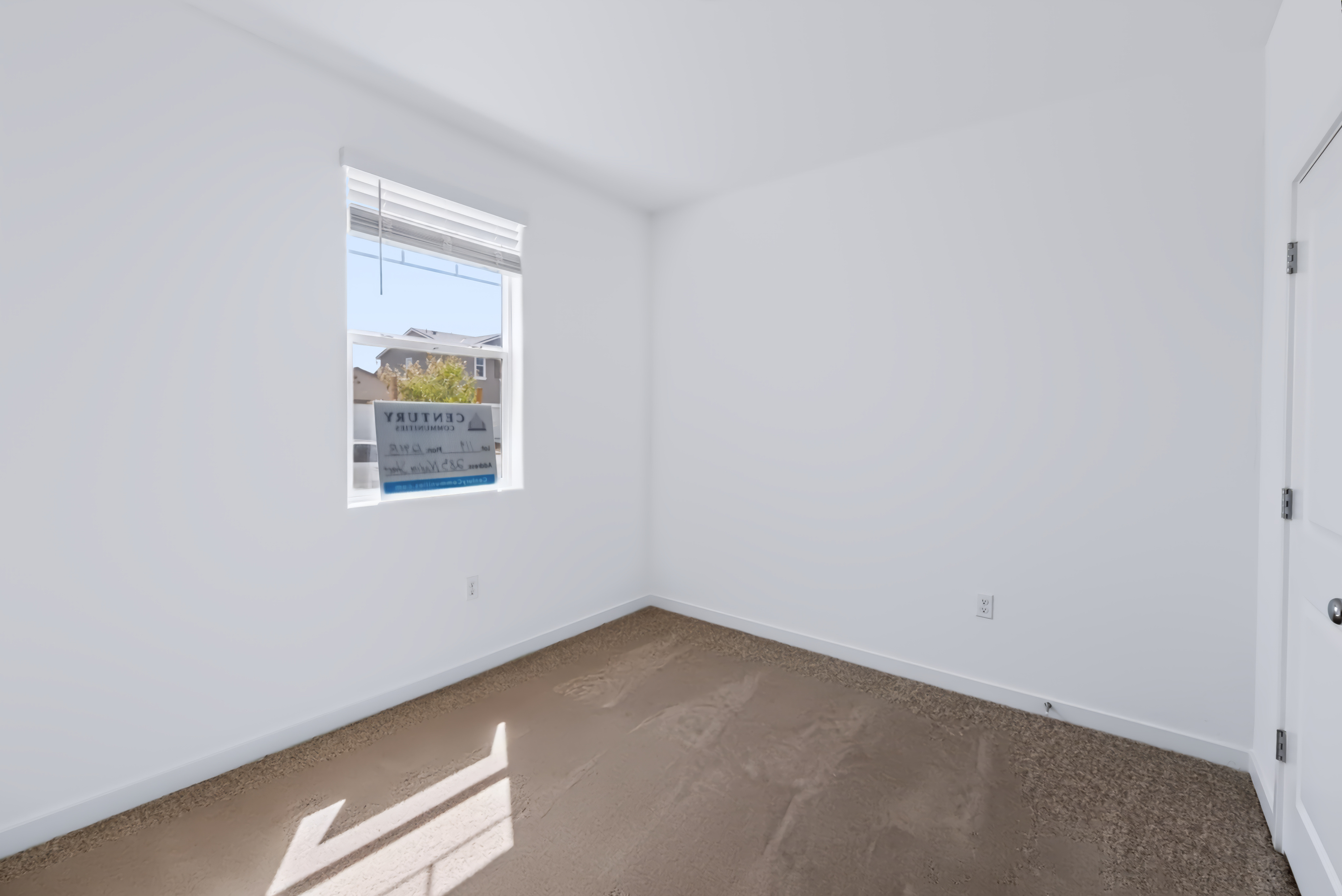 A room with a window and a door.