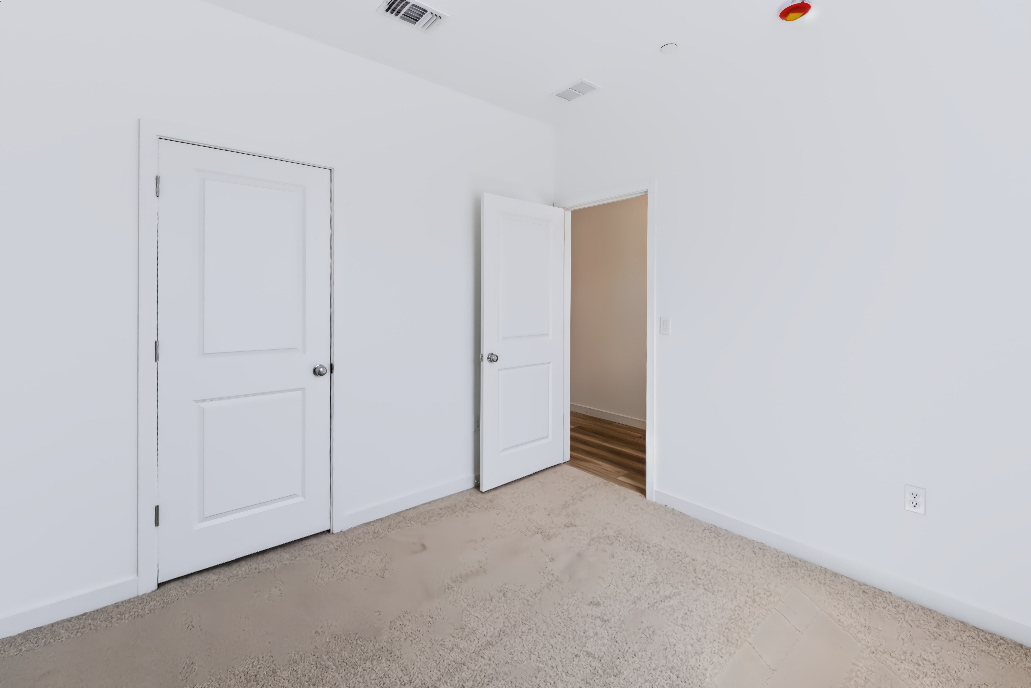 A hallway with white doors.