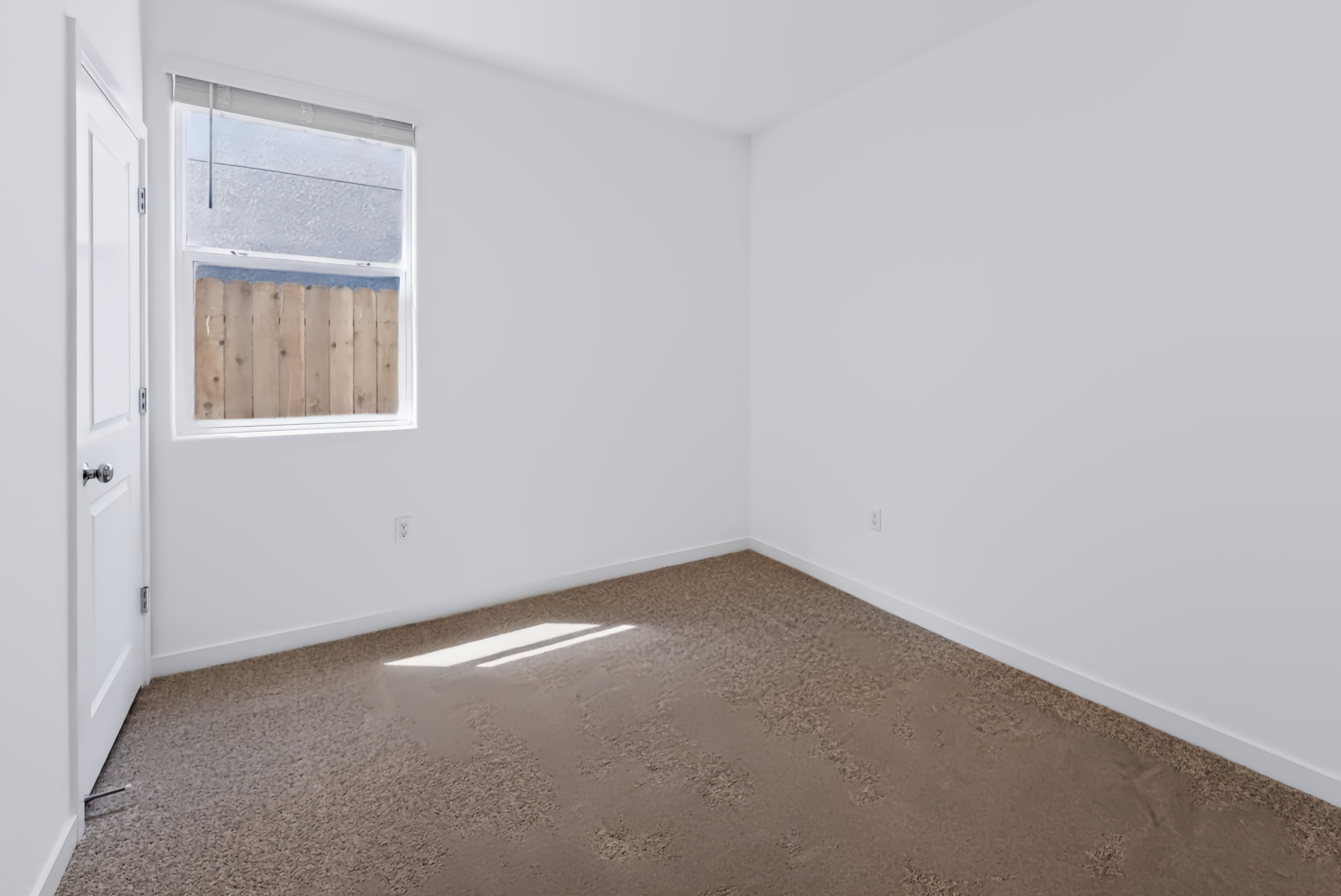 A room with a window and a door.
