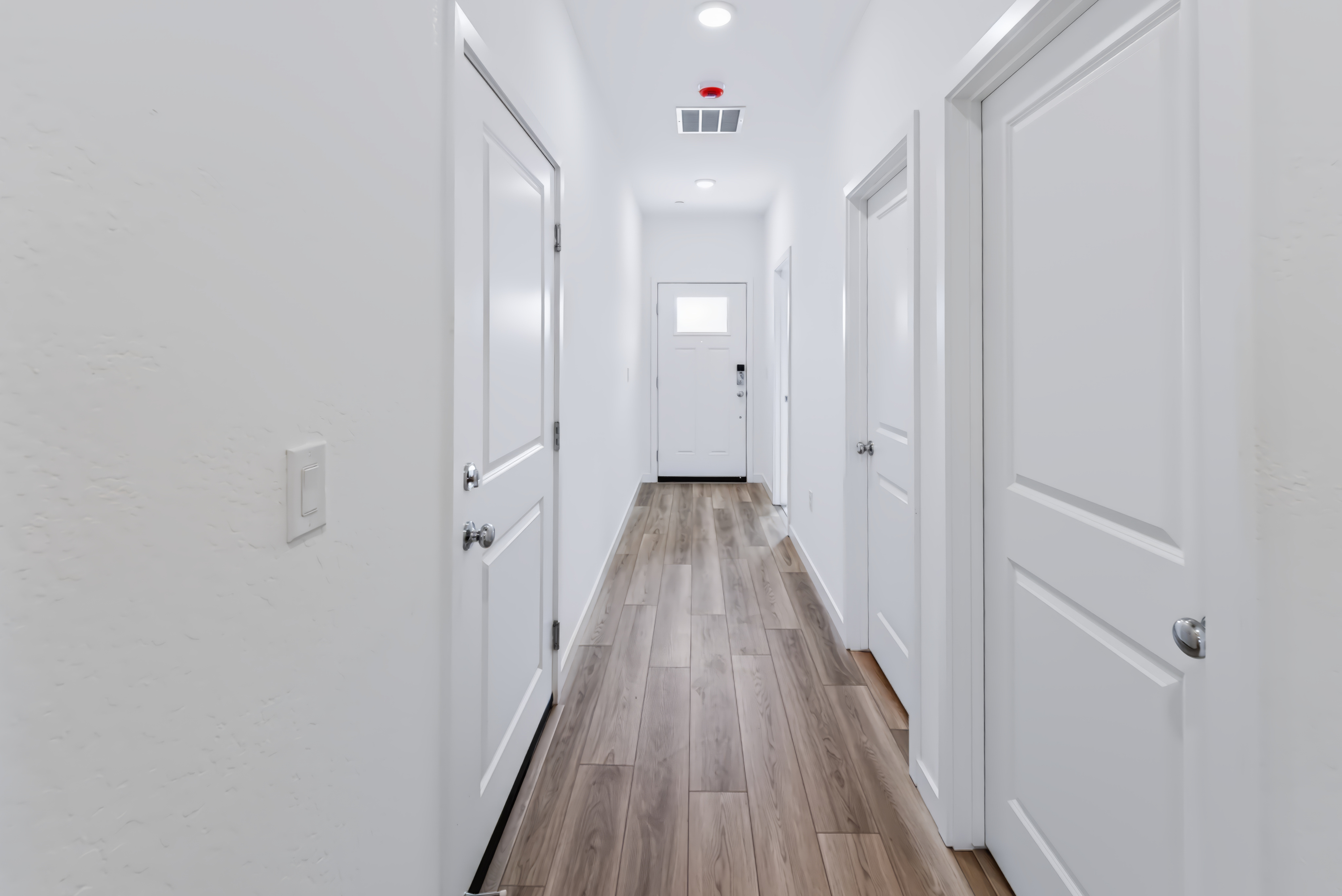 A hallway with white doors.