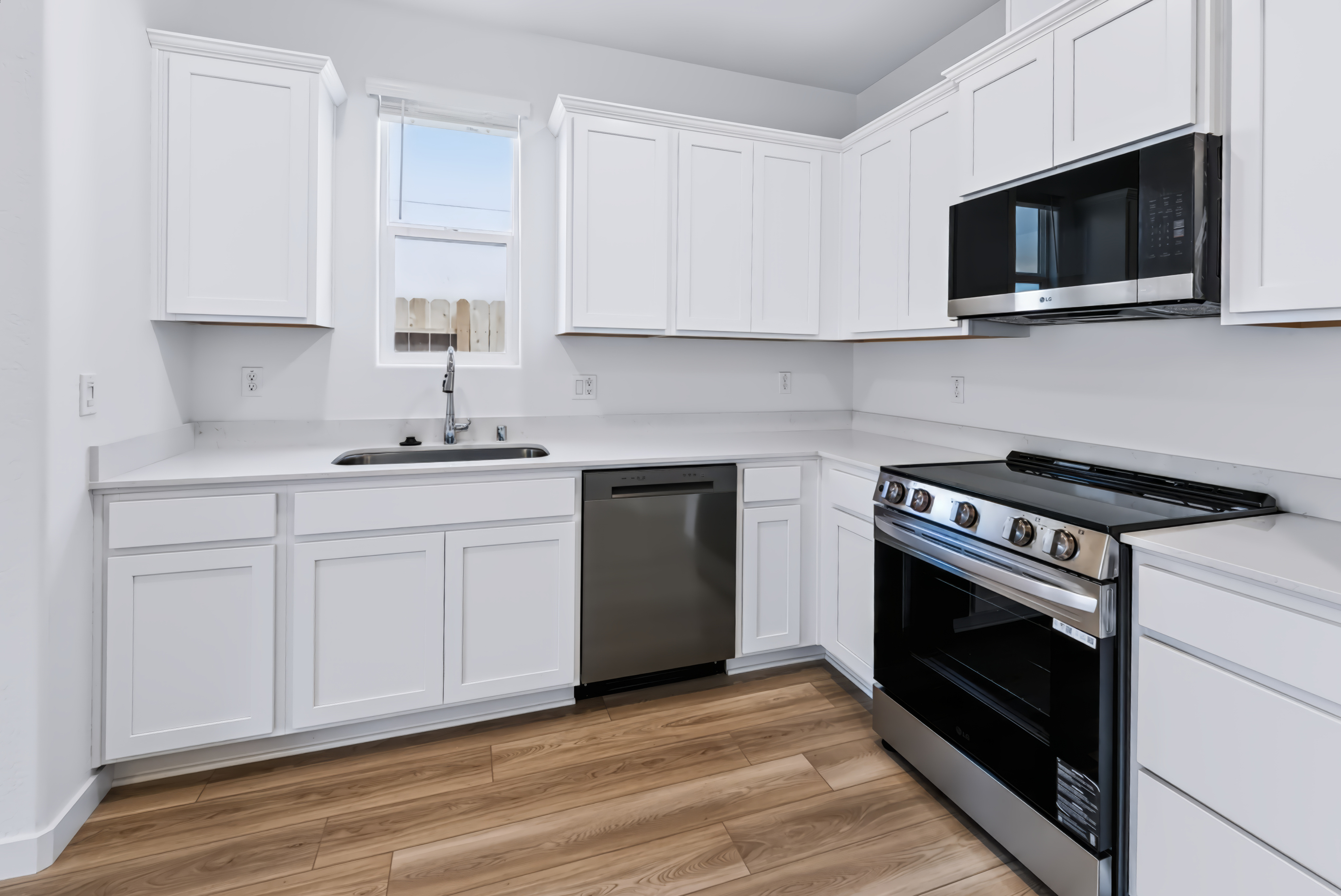 A kitchen with white cabinets.