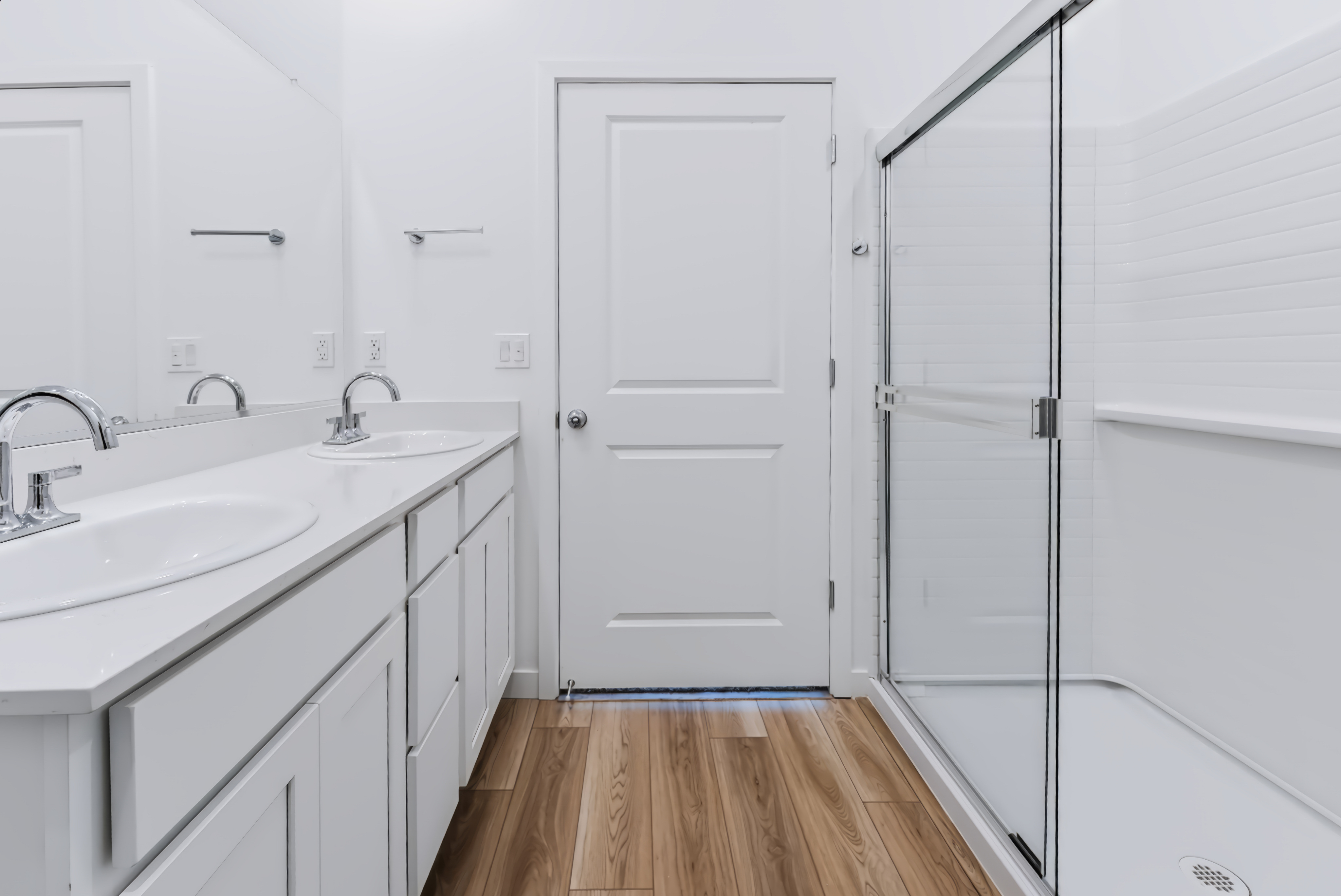 A bathroom with white cabinets.