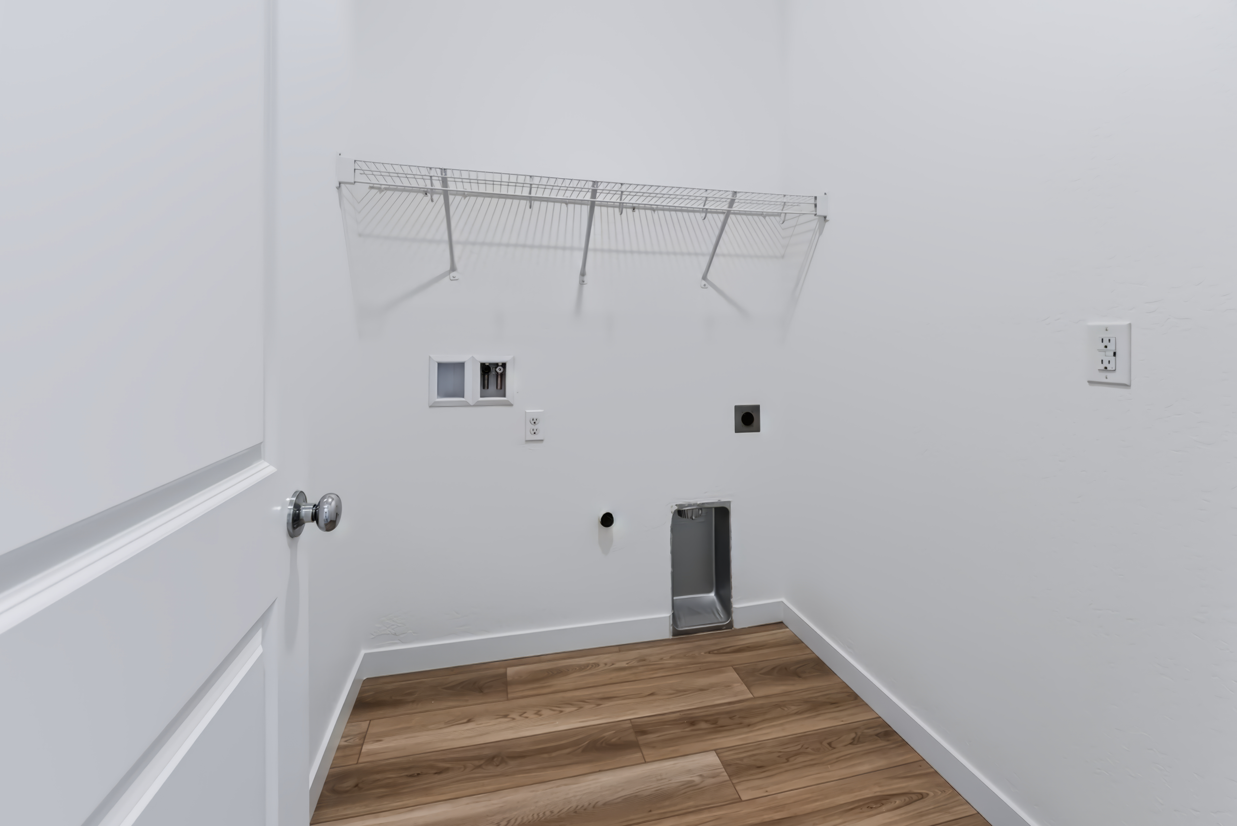 A room with a wood floor and a metal railing.