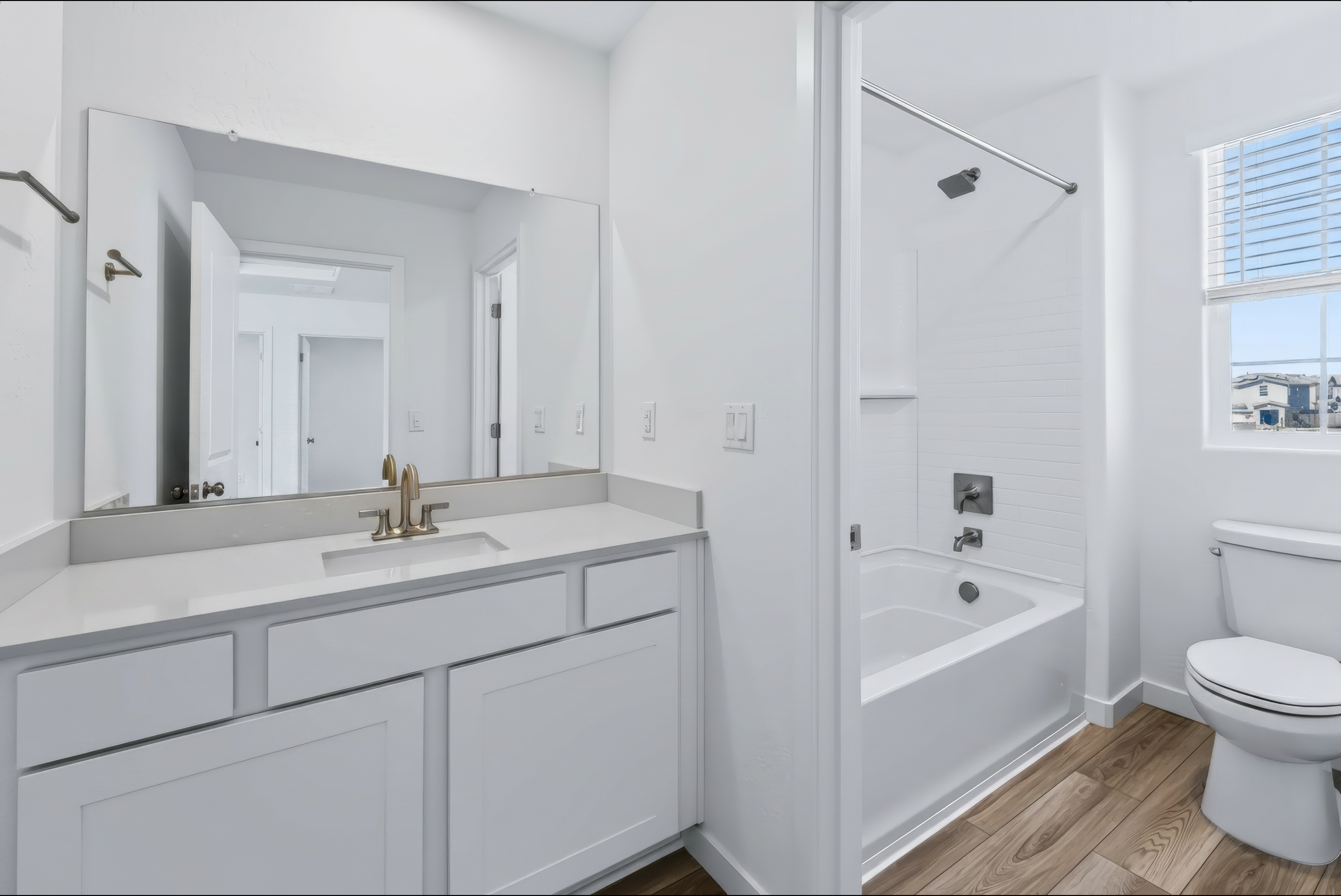 A bathroom with a tub sink and toilet.