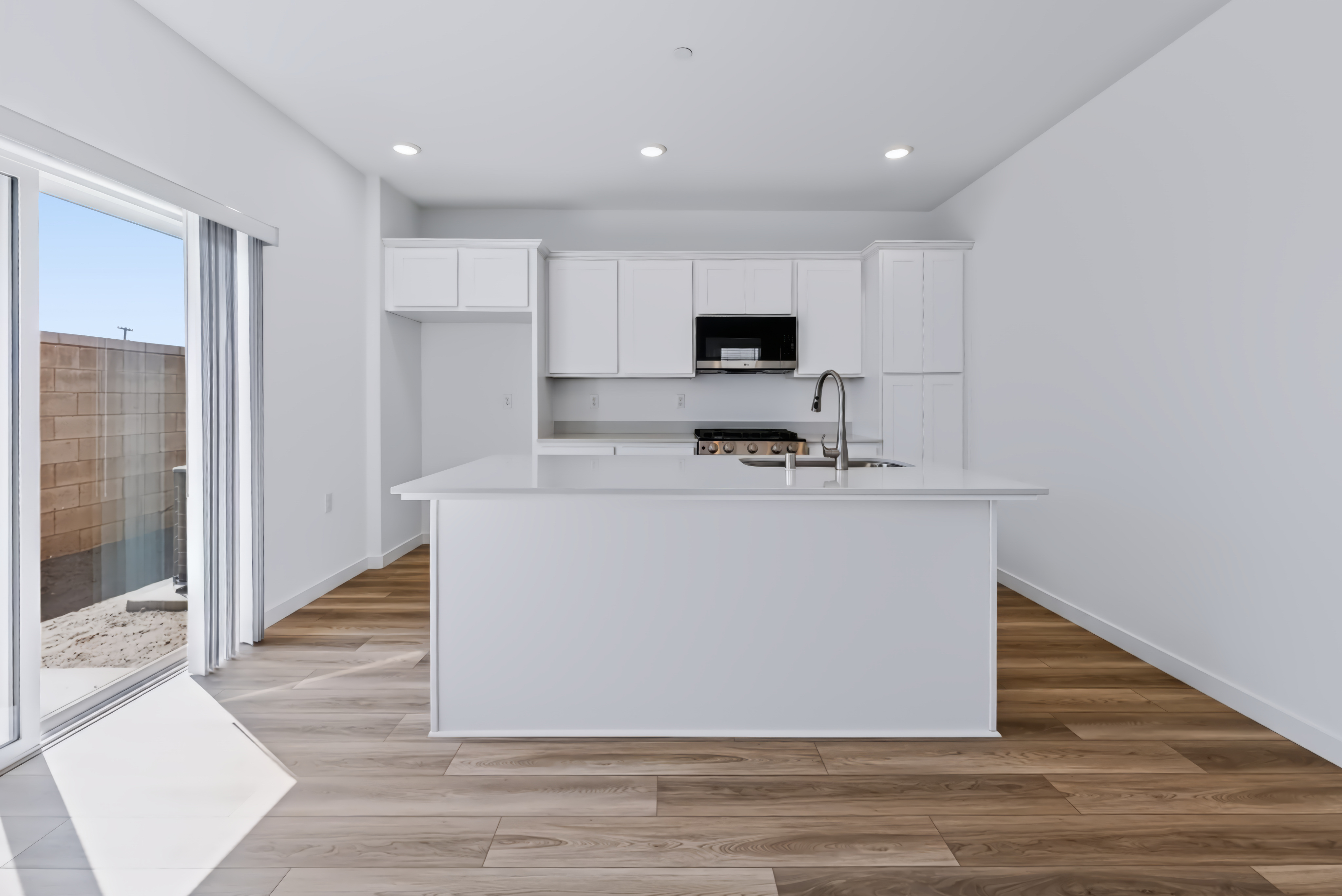 A white kitchen with white cabinets.