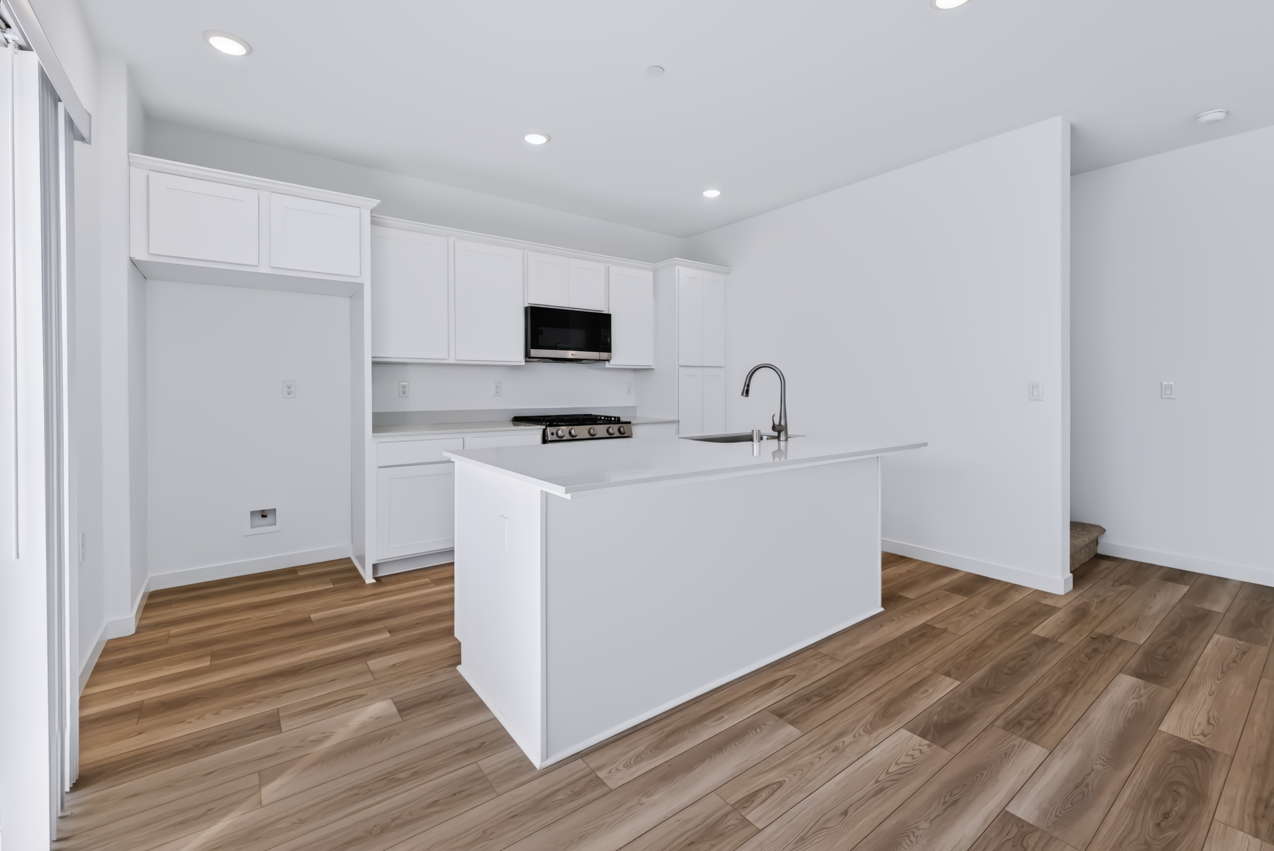 A kitchen with white cabinets.