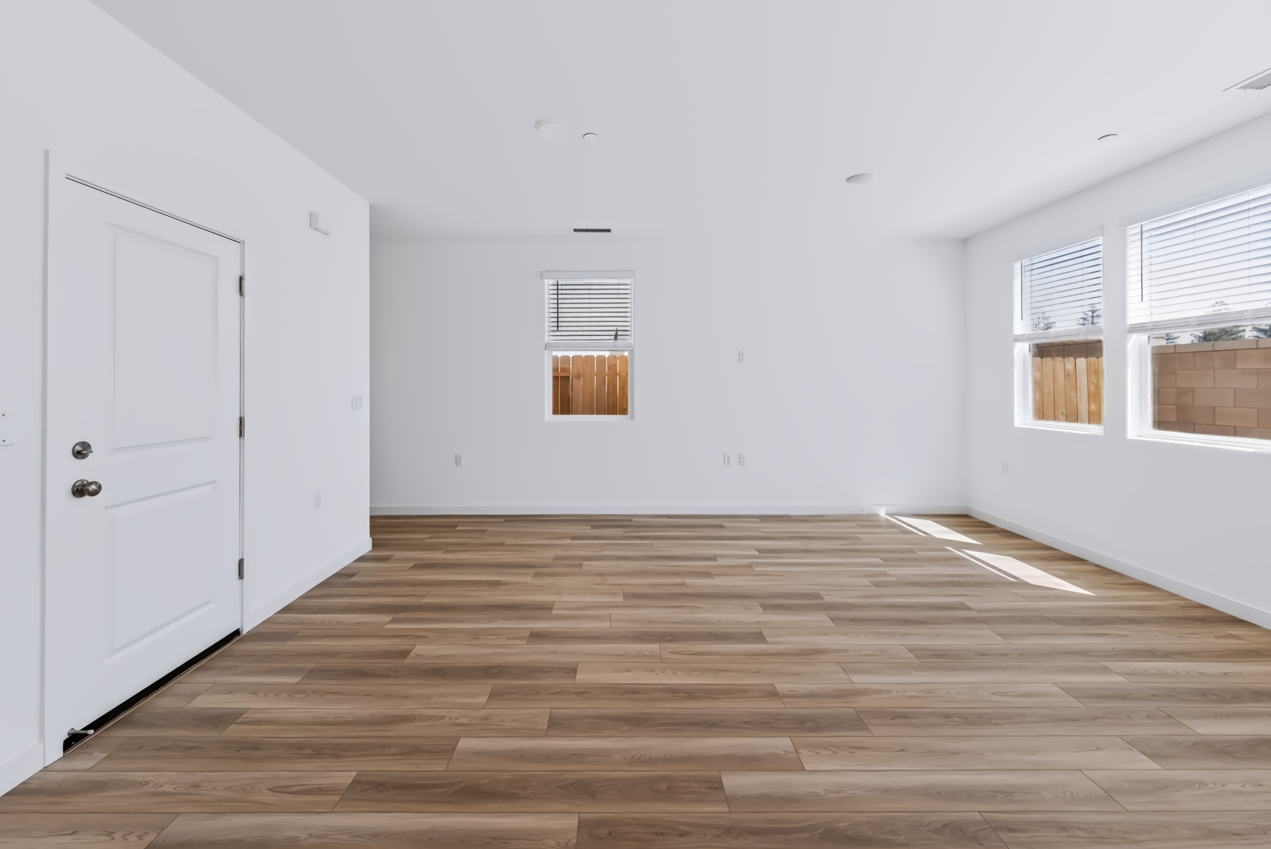 A room with a wood floor and white doors.