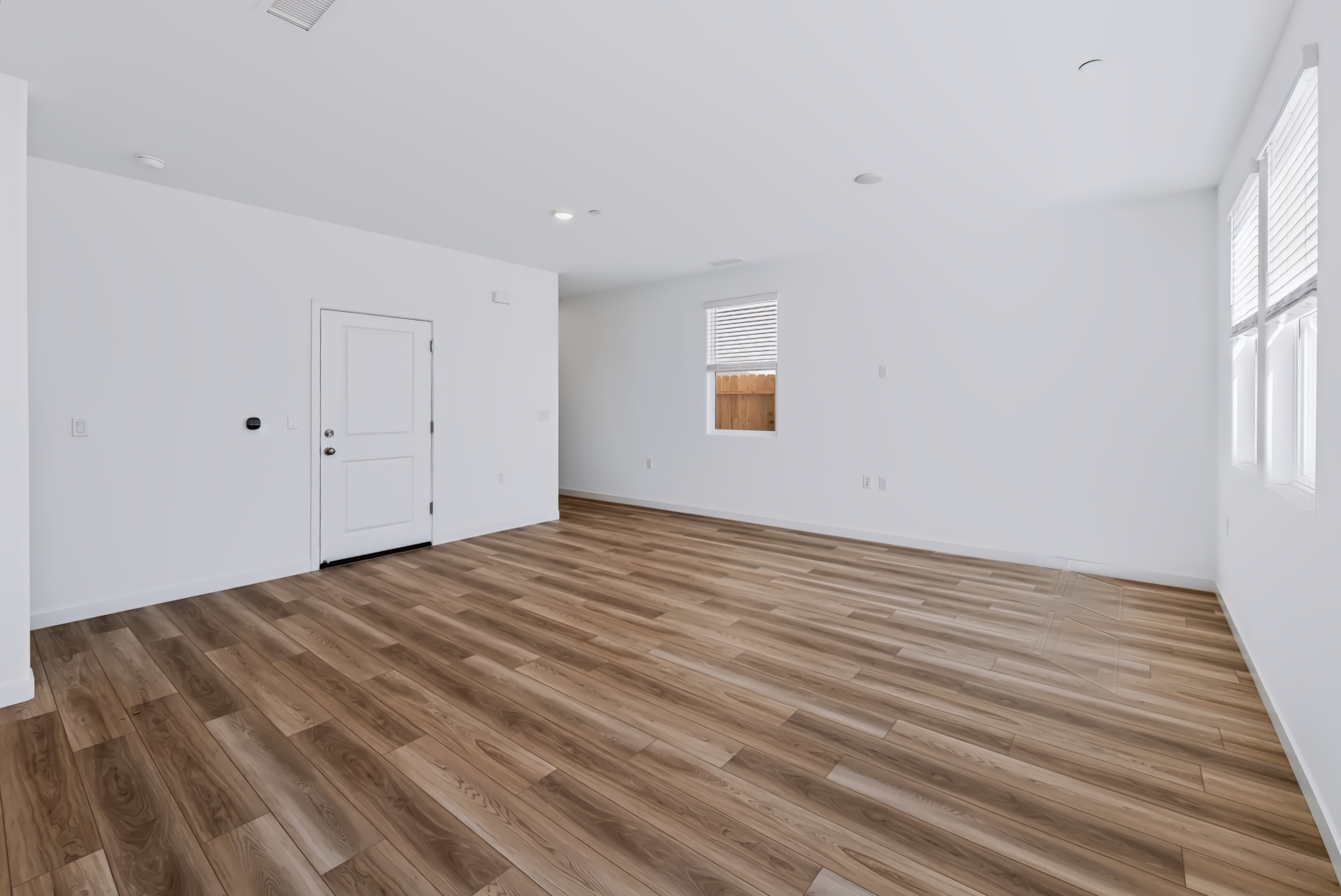 A room with a wood floor and white doors.