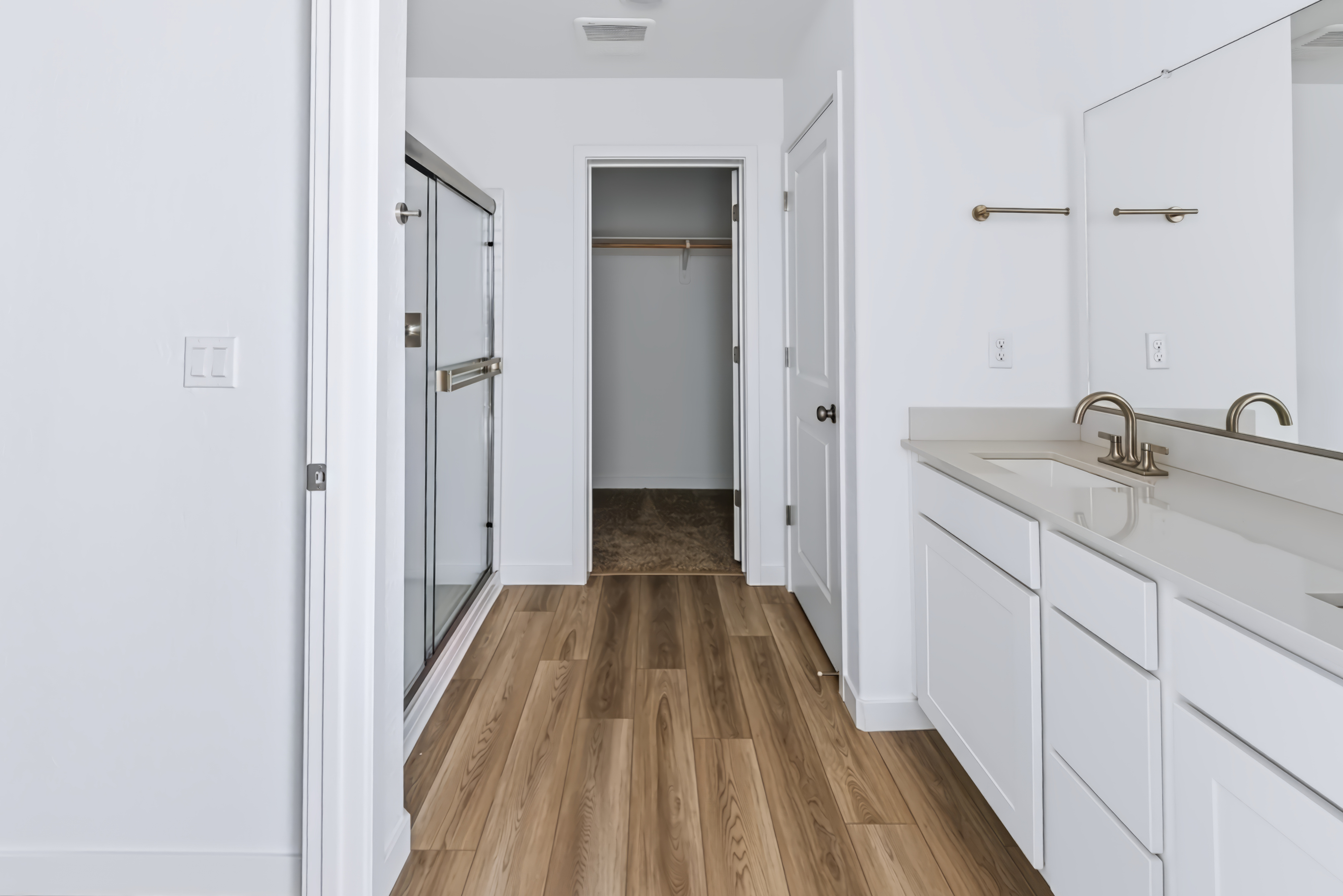 A bathroom with white cabinets.