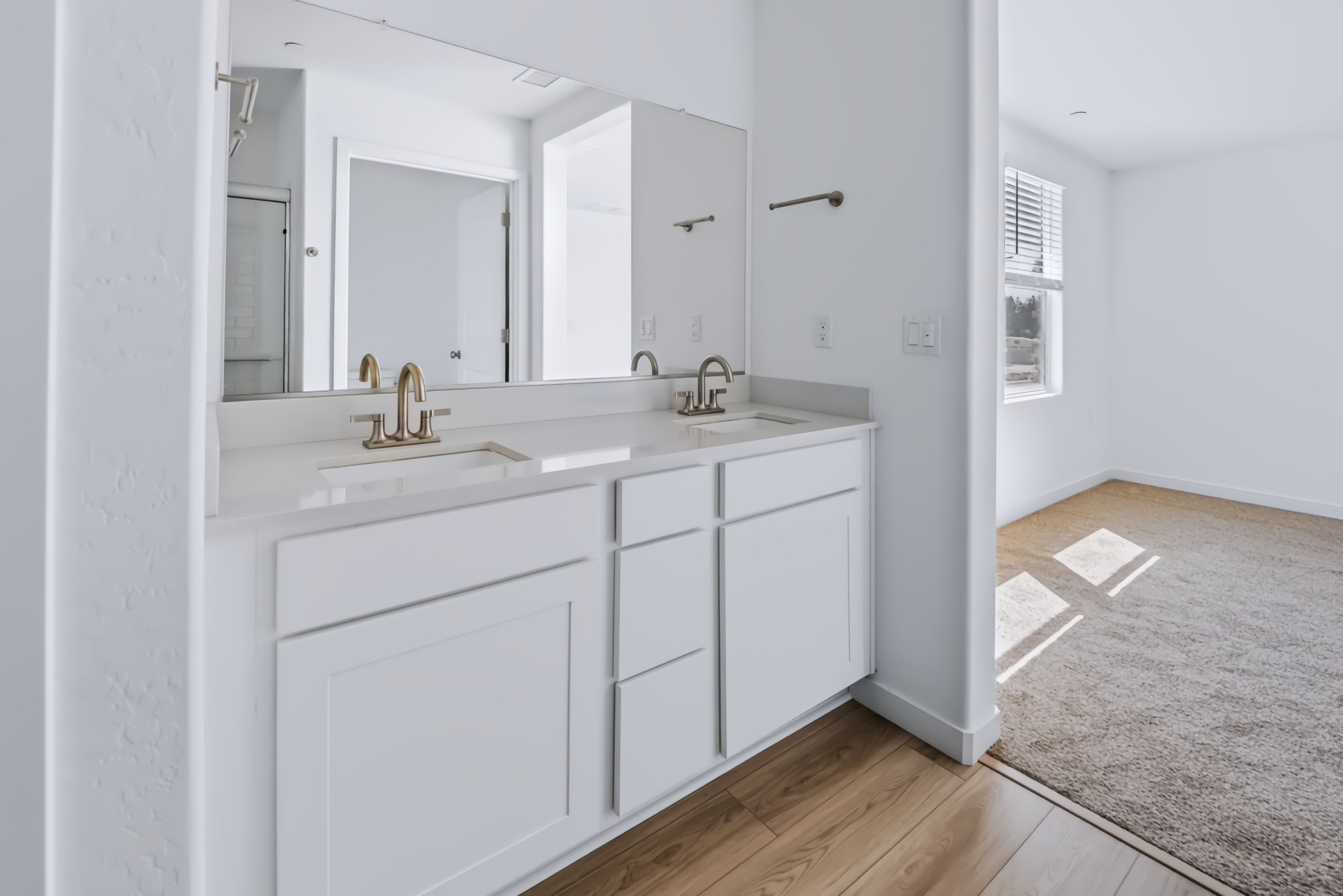 A bathroom with white cabinets.