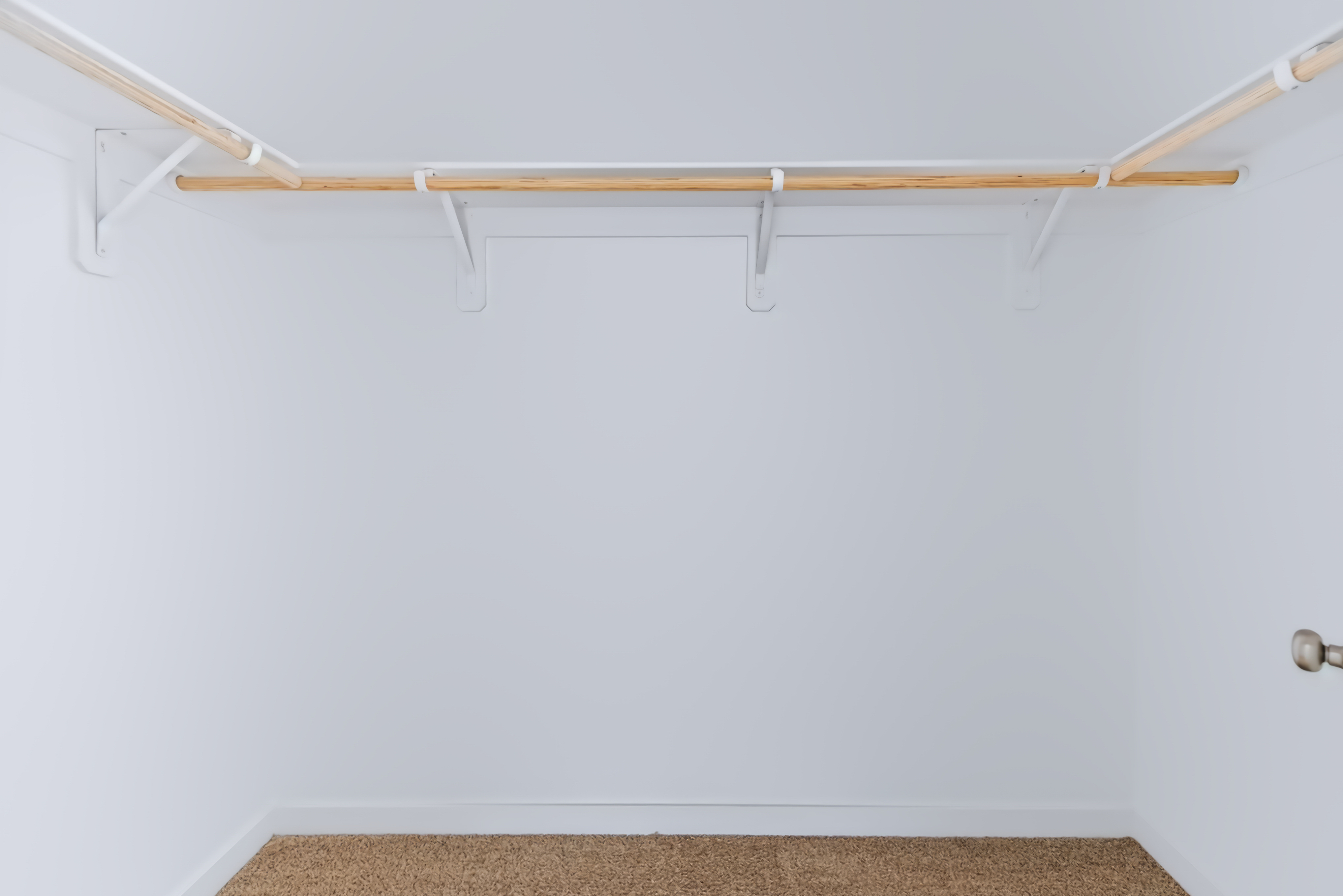 A white wall with a wooden frame.