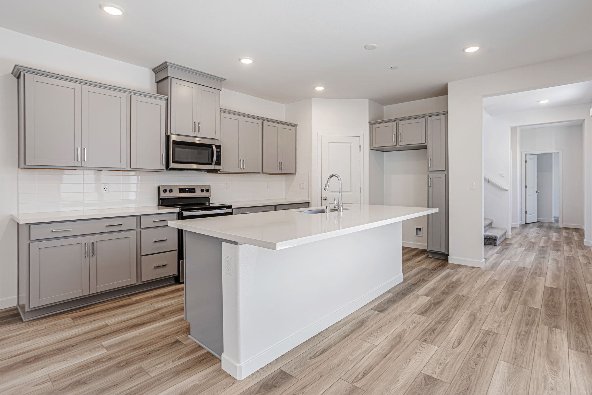 A kitchen with white cabinets.