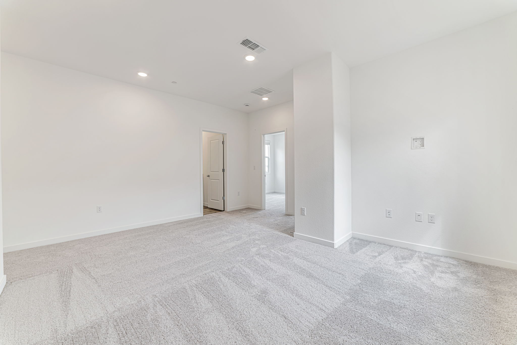 A long hallway with white walls.