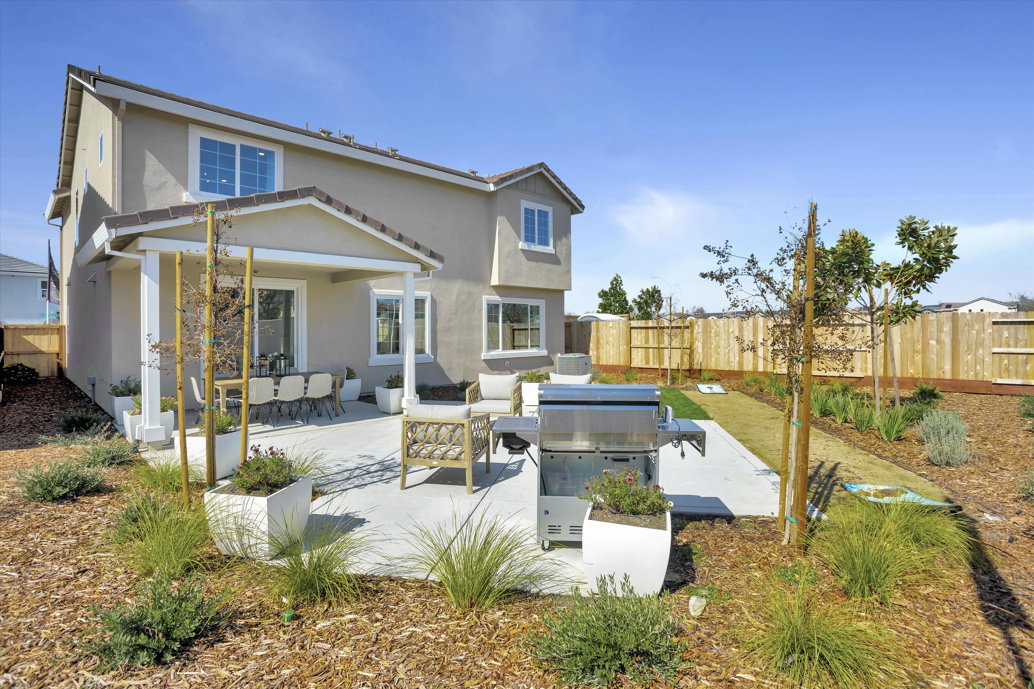 A house with a yard and a fence.