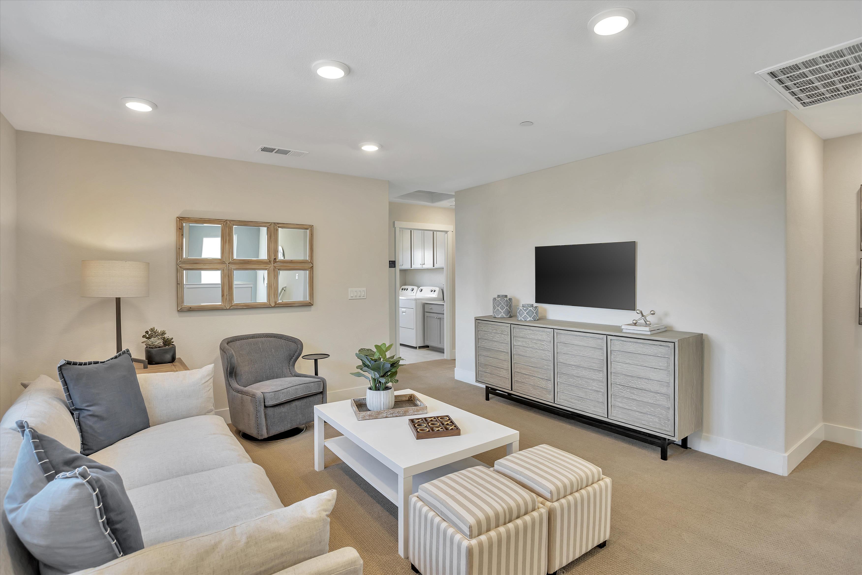 A living room with a tv and couches.