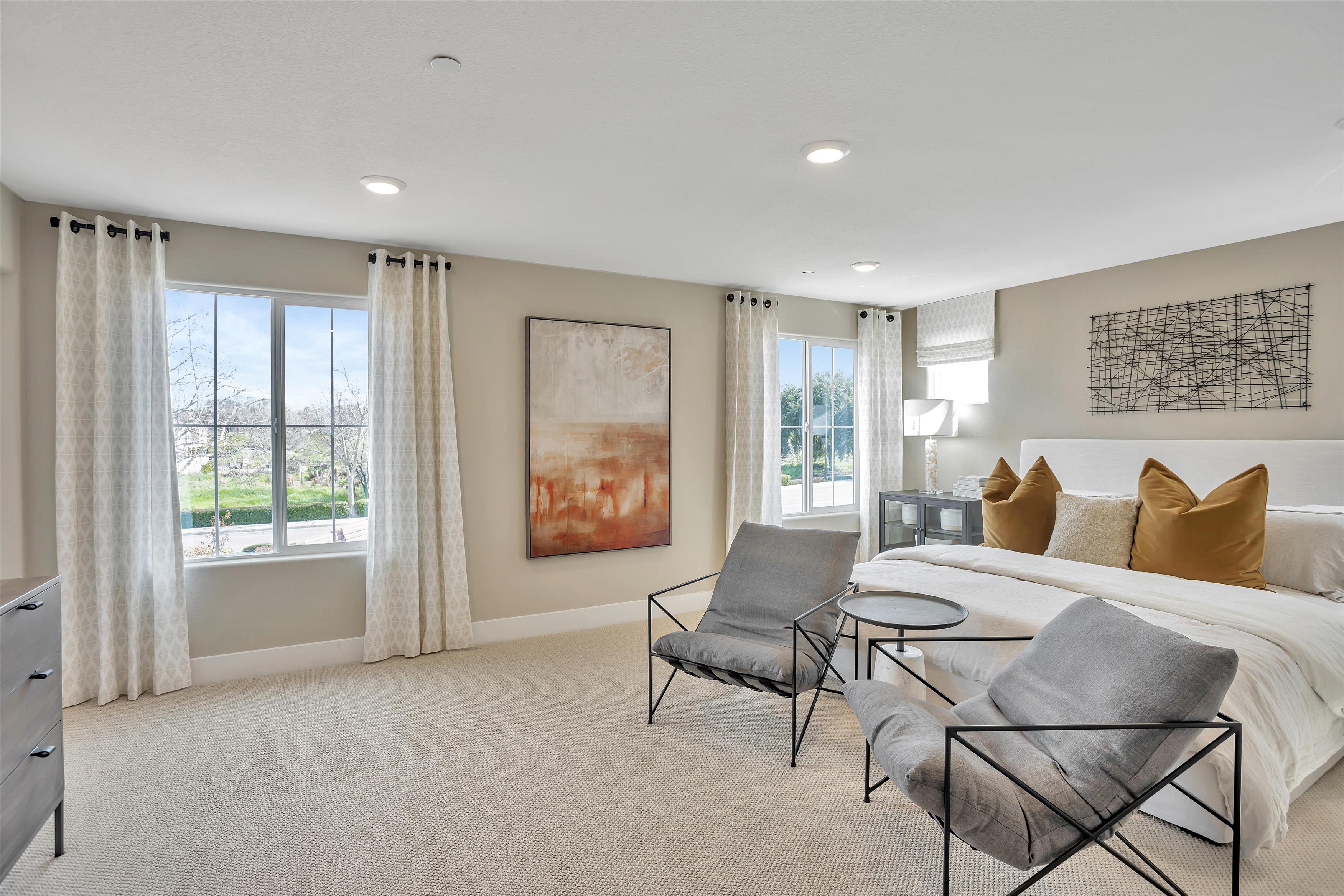 A room with a bed and a chair.