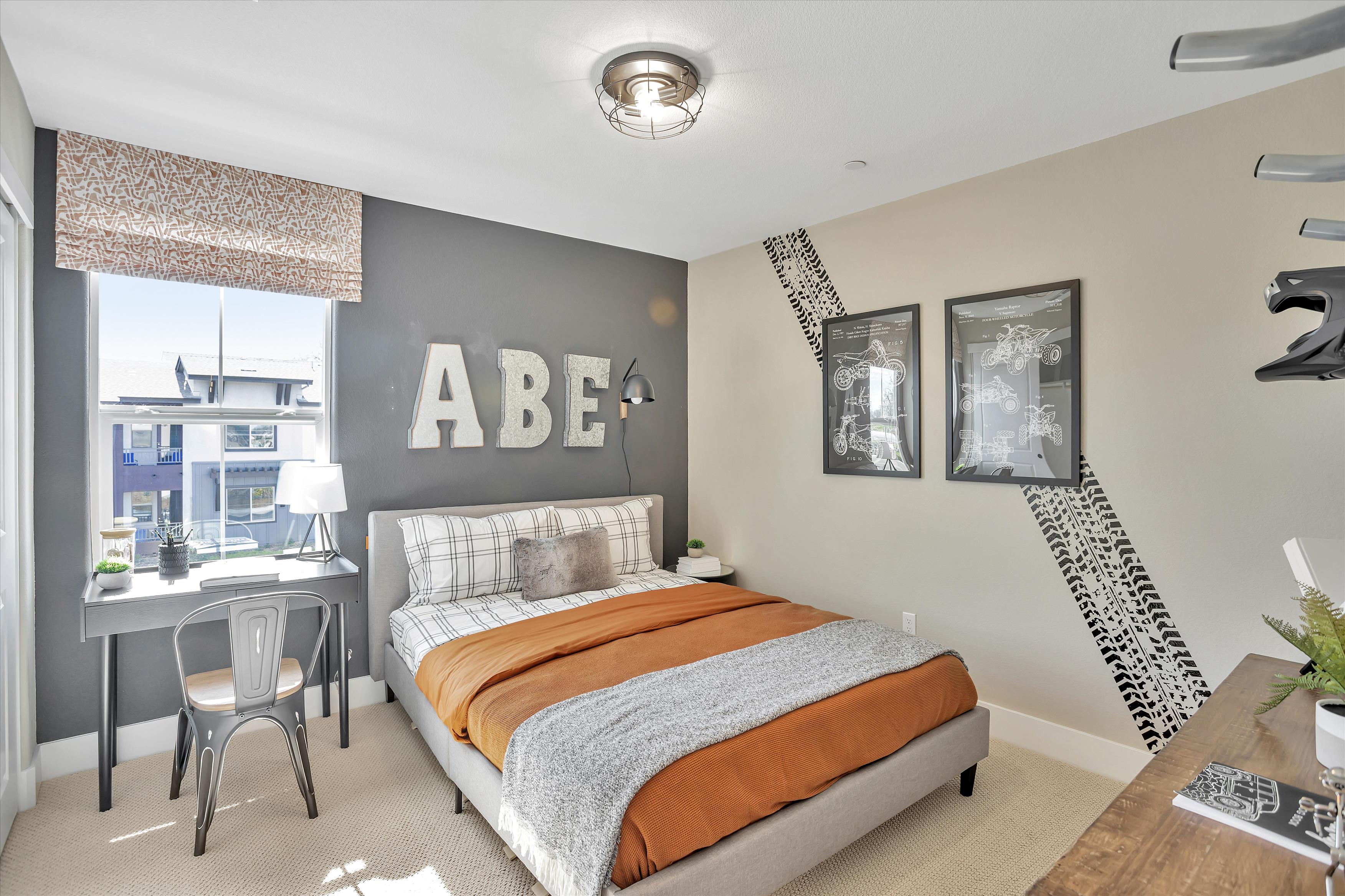 A bedroom with a bed and desk.