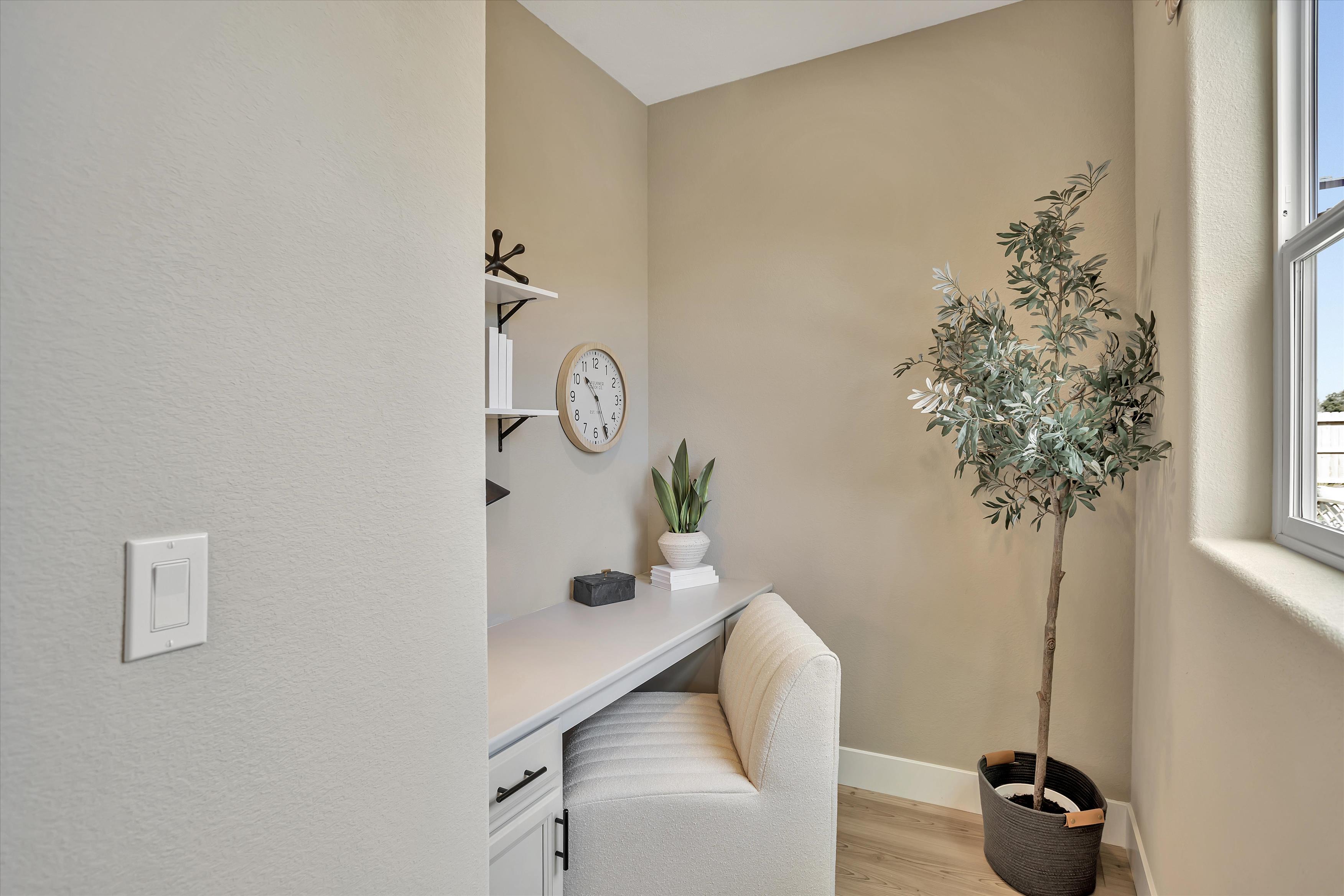 A room with a desk and a chair.